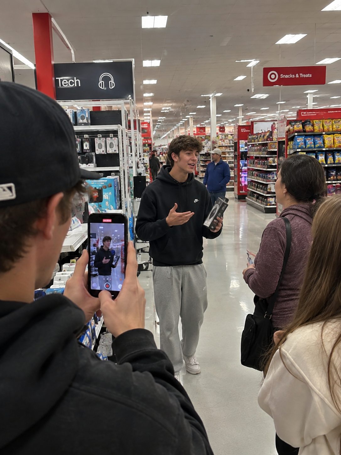 A creator filming a tech review in a Target aisle